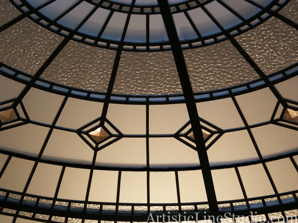stained and leaded glass dome with jewels and beveled glass lit with artificial light