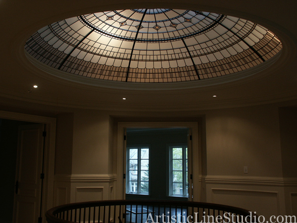 stained and leaded glass dome with jewels and beveled glass lit by soft light