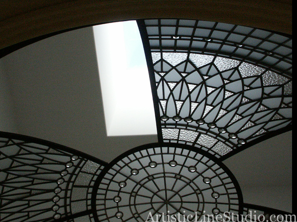 stained and leaded glass dome with jewels and beveled glassduring glass installation
