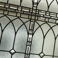 stained and leaded glass window with clear textured glass and beveled glass in English Manor style for stair case landing
