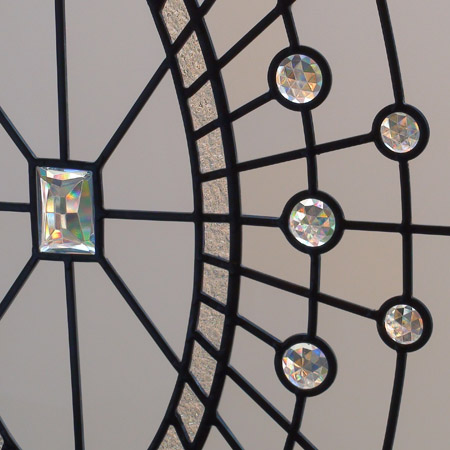 stained and leaded oval closet window with crystal jewels and acid etched glass
